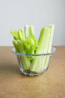 Close up fresh celery in glass bowl. photo