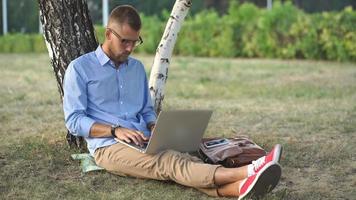 Man using a laptop outdoors