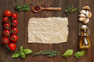 Craft paper with border of vegetables,  herbs and olive oil photo