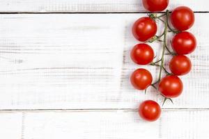 cherry tomatoes on white wooden background