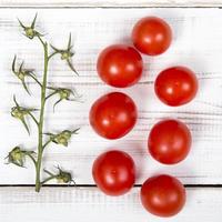cherry tomatoes on white wooden background