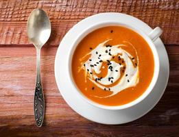 Pumpkin Soup with tomatoes, chili, yogurt and black sesame seeds photo