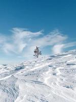 Snow covered mountain under blue sky photo