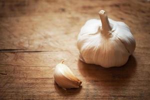 raw garlic on a wooden plank