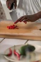 Young African Woman Cooking Salad photo