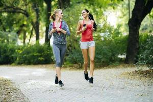 Sportive women jogging in park photo