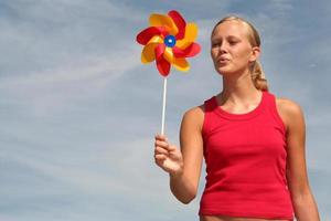Young Woman Blowing Pinwheel