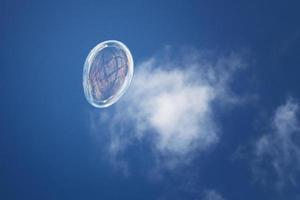 Soap bubble on the sky background photo