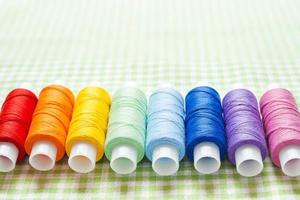 row of thread spools in rainbow colors