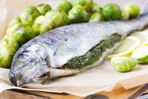 Two fish, trout stuffed with green herb sauce, brussels sprouts
