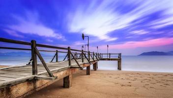 Long exposure of colorful sunrise and wooden pier