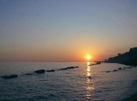 Round sun falling down over the Black sea