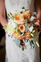 Wedding bouquet with Roses, Dahlias, Lisianthus, and Dusty Miller flowers photo