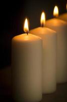 Candles light burning close-up plain black background