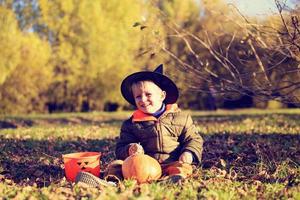 little boy in halloween costume at autumn park