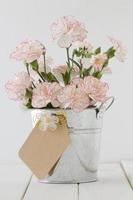 Carnations with Gift Tag in a Bucket photo