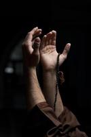 Hands Holding A Muslim Rosary photo