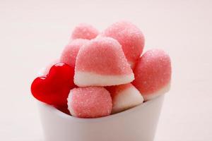 Pink jellies or marshmallows with sugar in bowl