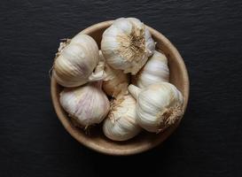 Garlic heads in a wooden bowl