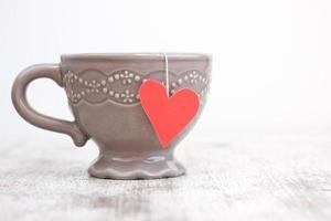 cup with heart shaped tea bag