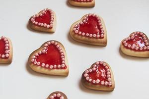 Red hearts cookies on white background
