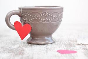 cup with heart shaped tea bag