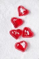 Red heart shaped jelly on powdered sugar-like snow