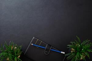 Notebook and pencil on the desk photo