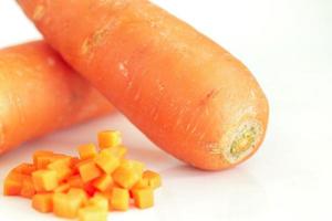 Fresh carrot and pieces isolated on white background photo