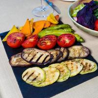 Grilled vegetables on slate board photo