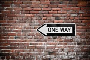 One Way Sign with Grunge Brick Wall Background