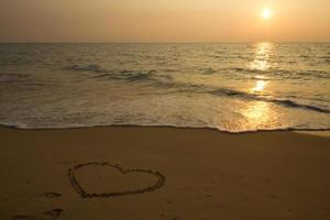 Heart drawing on the beach photo