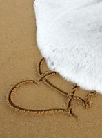 Two Love Hearts on Sand. photo