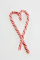 Candy canes in heart shape photo