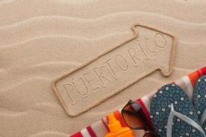 Puerto Rico  pointer and beach accessories lying on the sand photo