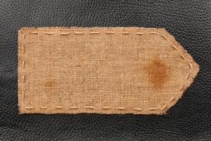 Arrow of burlap, lies on a background of leather photo