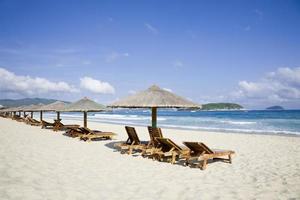 lounge chairs  and umbrellas by the sea photo