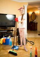 girl cleaning up living room with swab and scoop
