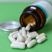 A lot of capsule pills on the table photo