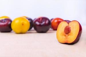 Sliced plum fruit close up on white background photo