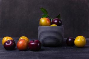 Colorful plum fruit in a pot  photo