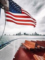 waving US flag on a boat photo