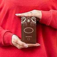 Woman holding perfume box photo