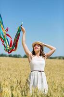 Happy girl holding colorful ribbons