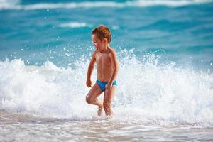 happy boy kid having fun in sea water