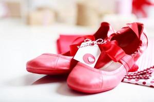 Red shoes with ribbon and heart tag photo