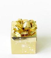 gold festive gift box with bow on top