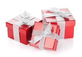 Three red gift boxes with silver ribbon and bow photo