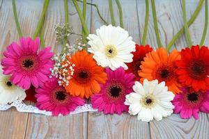 Bunch of gerber daisies and baby's breath on old wood