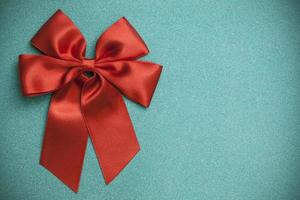Red ribbon on a shiny green background photo